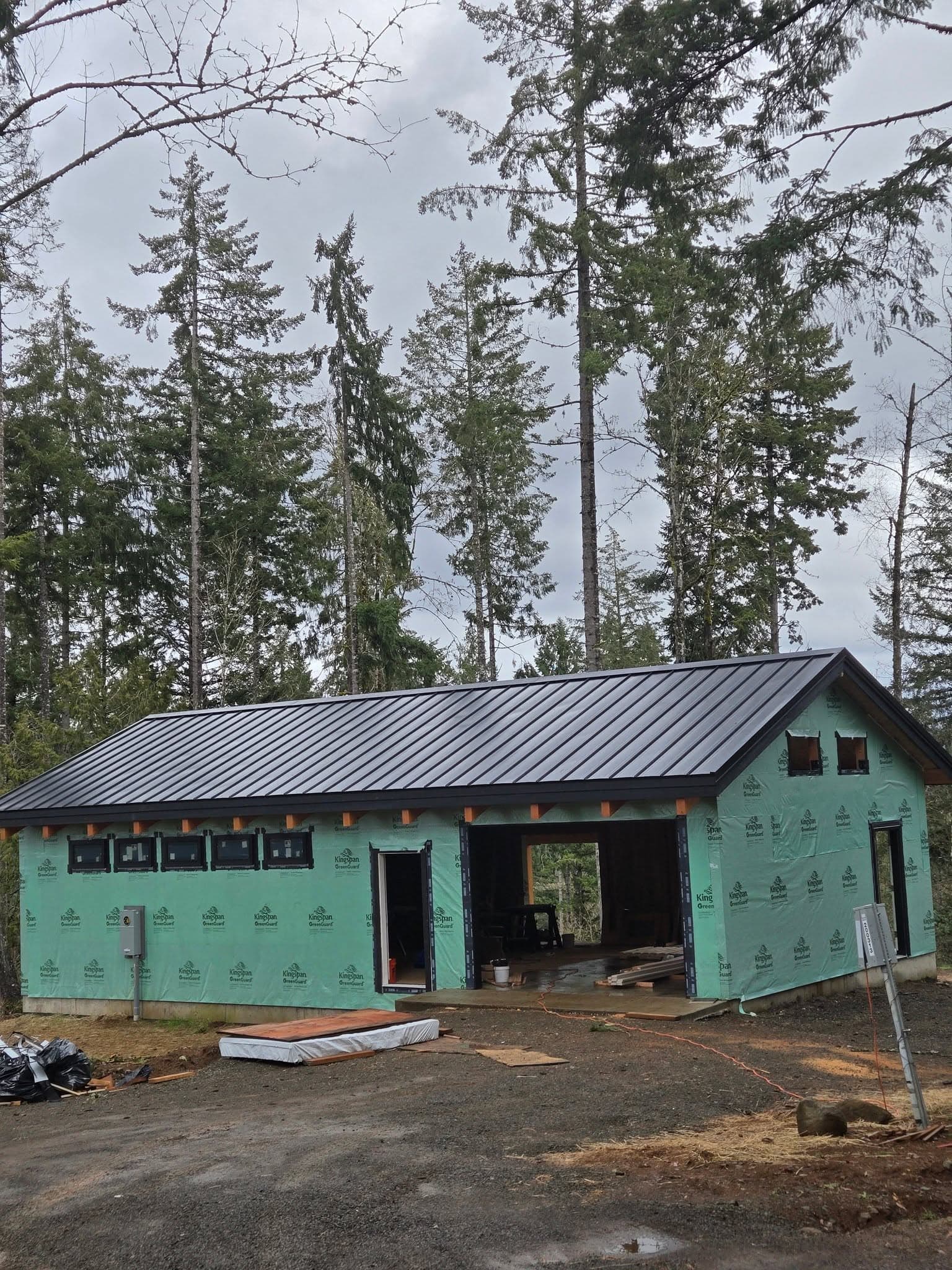 Standing seam metal roof on a workshop in the Pacific Northwest forest